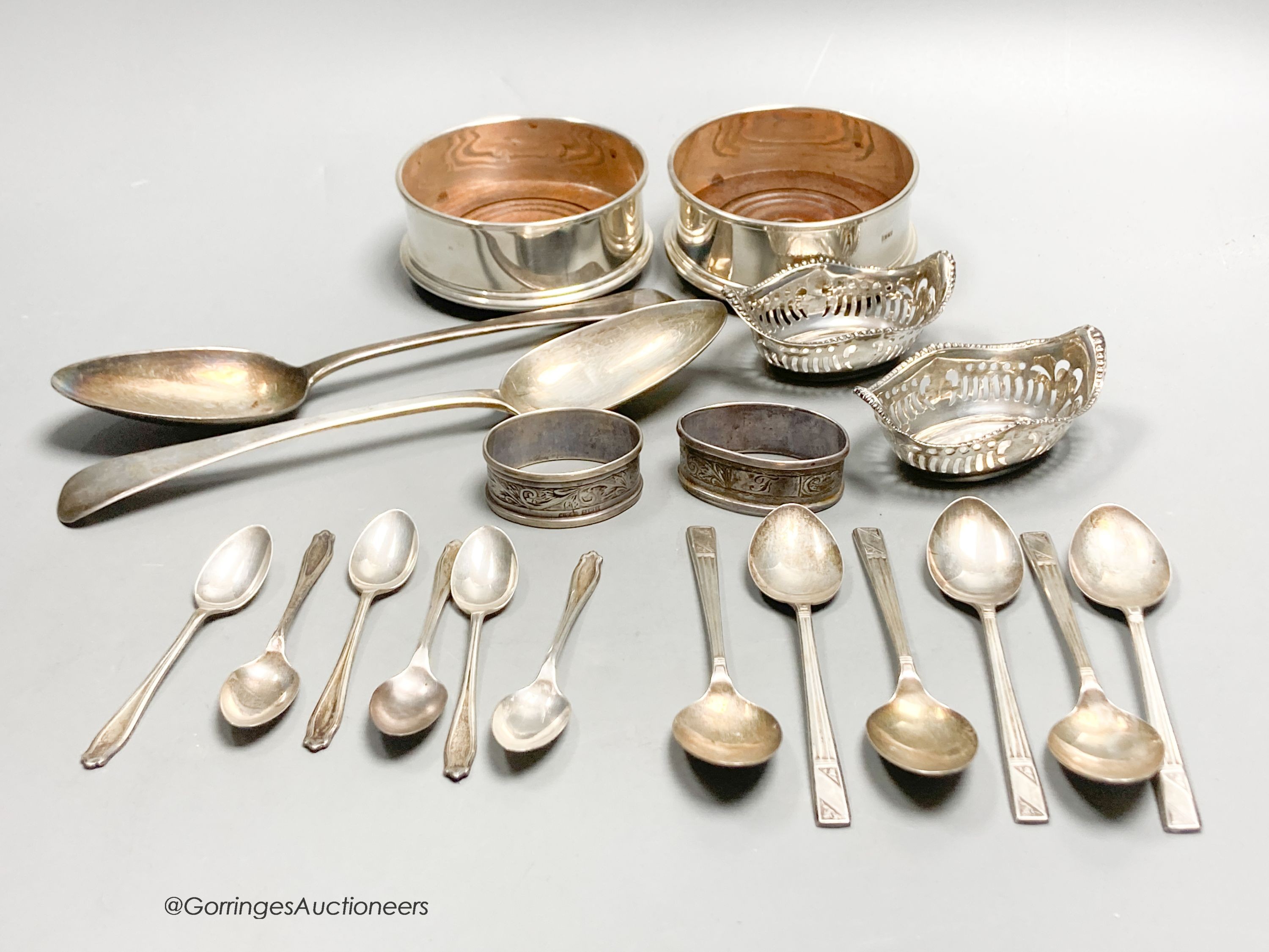 A pair of George III silver tablespoons, a pair of modern silver bottle coasters, a pair of pierced silver bon bon dishes, six silver teaspoons and 6 silver coffee spoons.